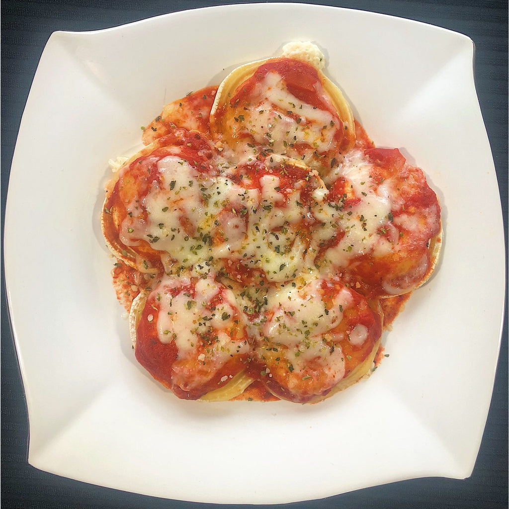 An image of cheese ravioli pasta. The dish consists of tender ravioli filled with a creamy cheese mixture. The pasta is cooked al dente and served in a bowl. It is generously coated in a savory tomato sauce, garnished with fresh basil leaves and a sprinkle of grated Parmesan cheese. The cheese ravioli pasta is a comforting and flavorful Italian dish.