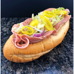  An image of an American cold cut sub sandwich. The sandwich is made with fresh ingredients including sliced turkey, ham, roast beef, and American cheese. It is garnished with lettuce, tomato, onion, pickles, and mayonnaise. The sub is served on a soft, freshly baked roll.