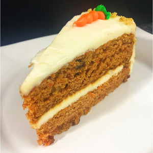 An image of a carrot cake. The cake is a round, layered dessert with a moist and dense texture. It is frosted with a creamy cream cheese icing and decorated with grated carrots and chopped walnuts on top. The carrot cake is beautifully presented on a cake stand, enticingly displaying its delicious and classic flavors.