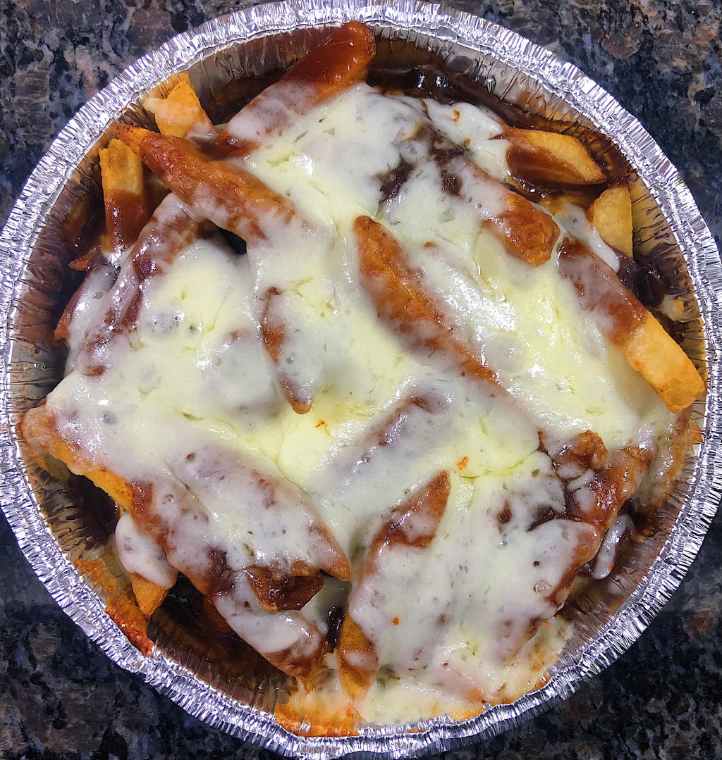 An image of cheesy gravy fries. The dish features a bed of golden-brown fries, smothered in a rich and savory gravy. The fries are topped with melted cheese, which adds a creamy and indulgent layer. The dish is garnished with chopped green onions, providing a fresh and vibrant touch. The cheesy gravy fries are a mouthwatering comfort food delight.