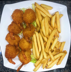 An image of a breaded shrimp platter. The platter features a generous serving of succulent shrimp coated in a crispy breading. The shrimp are golden brown and arranged neatly on a plate. The platter is accompanied by a side of cocktail sauce and garnished with lemon wedges, presenting a mouthwatering seafood dish.