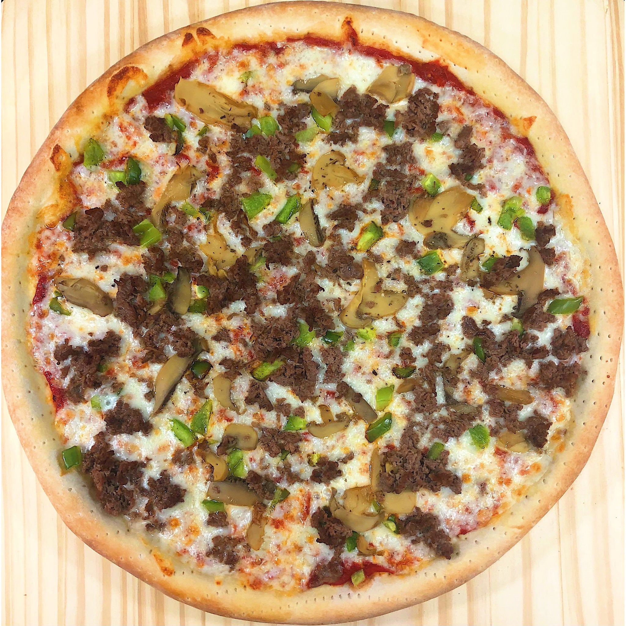  An image of a cheesesteak pizza. The pizza has a thin, crispy crust and is topped with slices of tender beefsteak, sautéed onions, bell peppers, and melted cheese. The combination of flavors mimics the iconic cheesesteak sandwich. The pizza is baked to perfection, with the cheese melted and slightly golden. It showcases a delicious fusion of two beloved dishes, the cheesesteak and pizza.
