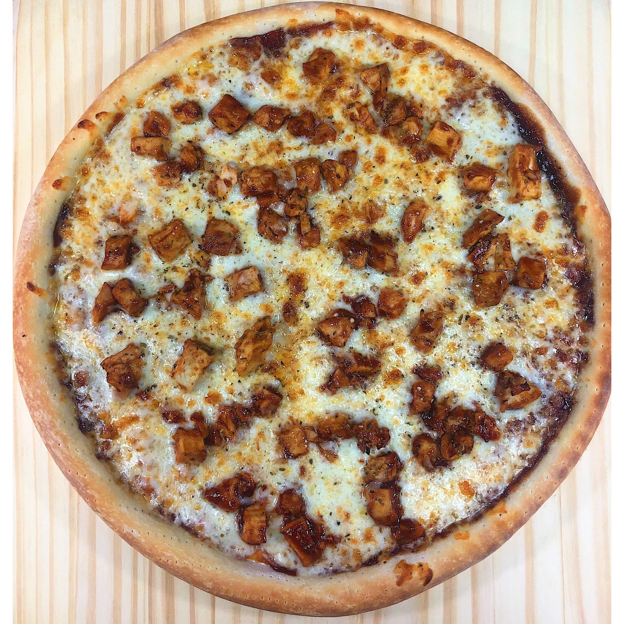 An image of a BBQ Chicken Pizza. The pizza features a thin and crispy crust topped with tangy barbecue sauce. It is generously layered with grilled chicken pieces, melted cheese, sliced red onions, and fresh cilantro. The pizza is baked to perfection, with a golden-brown crust and bubbly cheese.