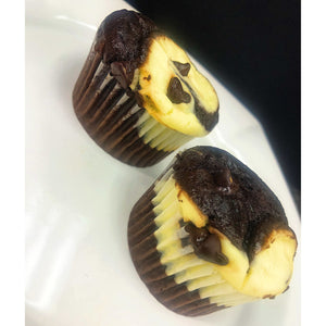 An image of Black Bottom cupcakes. The cupcakes have a moist chocolate base and a cream cheese filling. The tops of the cupcakes are sprinkled with chocolate chips. They are baked to perfection and displayed on a dessert platter.