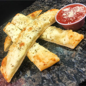 An image of breadsticks. The breadsticks are long and slender, with a light golden-brown color. They have a soft and fluffy interior, with a slightly crisp exterior. The breadsticks are arranged in a basket, invitingly presented and ready to be enjoyed. They make for a delightful appetizer or accompaniment to a meal.